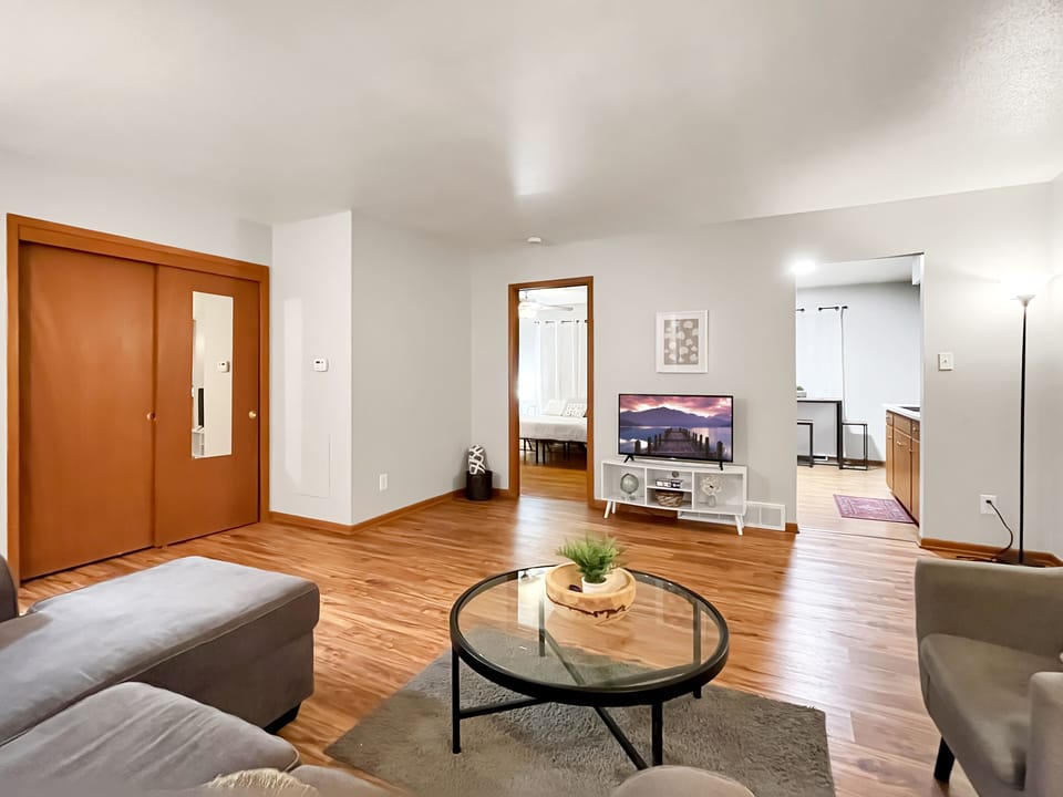 Living Room with smart TV, with entrances to Master bed and kitchen