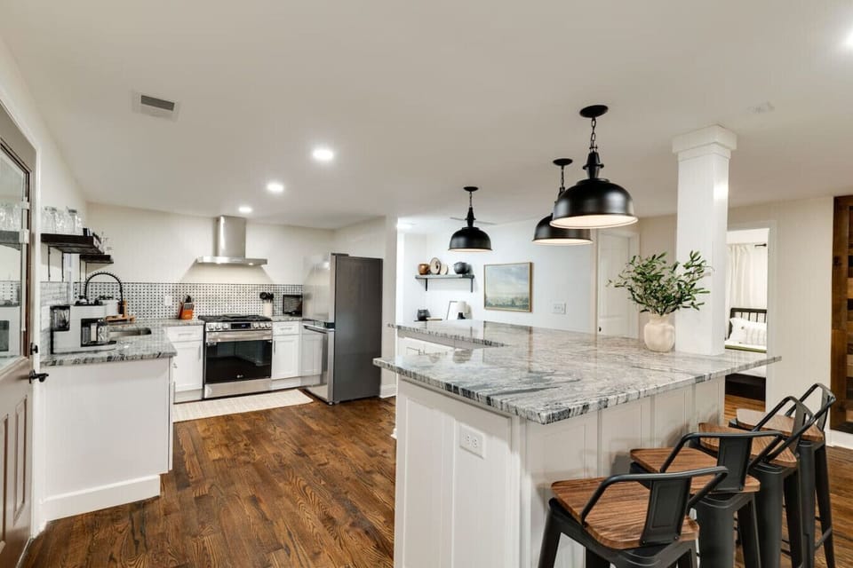 The kitchen and dining space features ample counter space, an L-shaped island, and a welcoming area for family meals and gatherings.