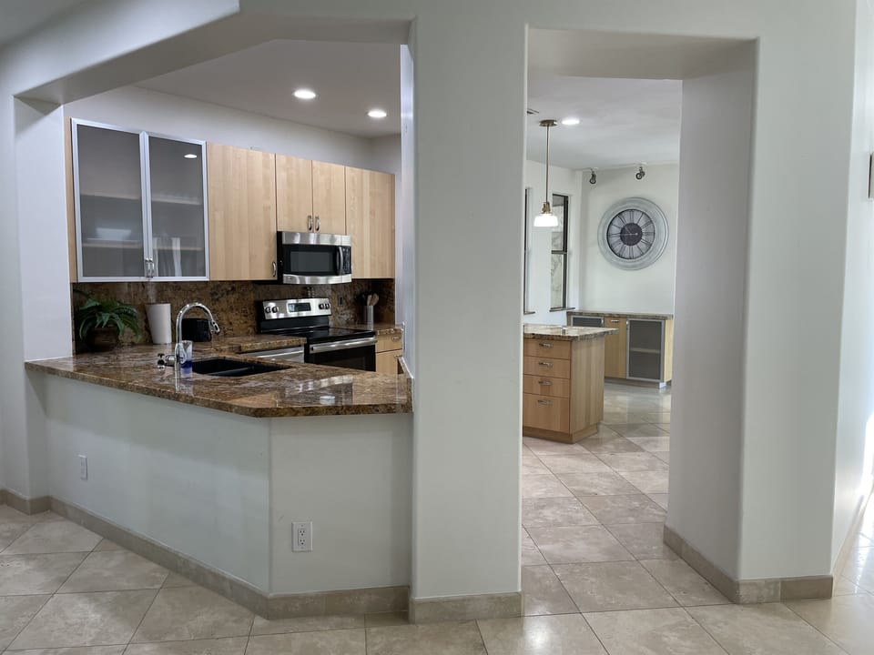 Fully-equipped kitchen with dishwasher, refrigerator, freezer with ice maker, 4-burner stovetop, microwave, oven and pantry.