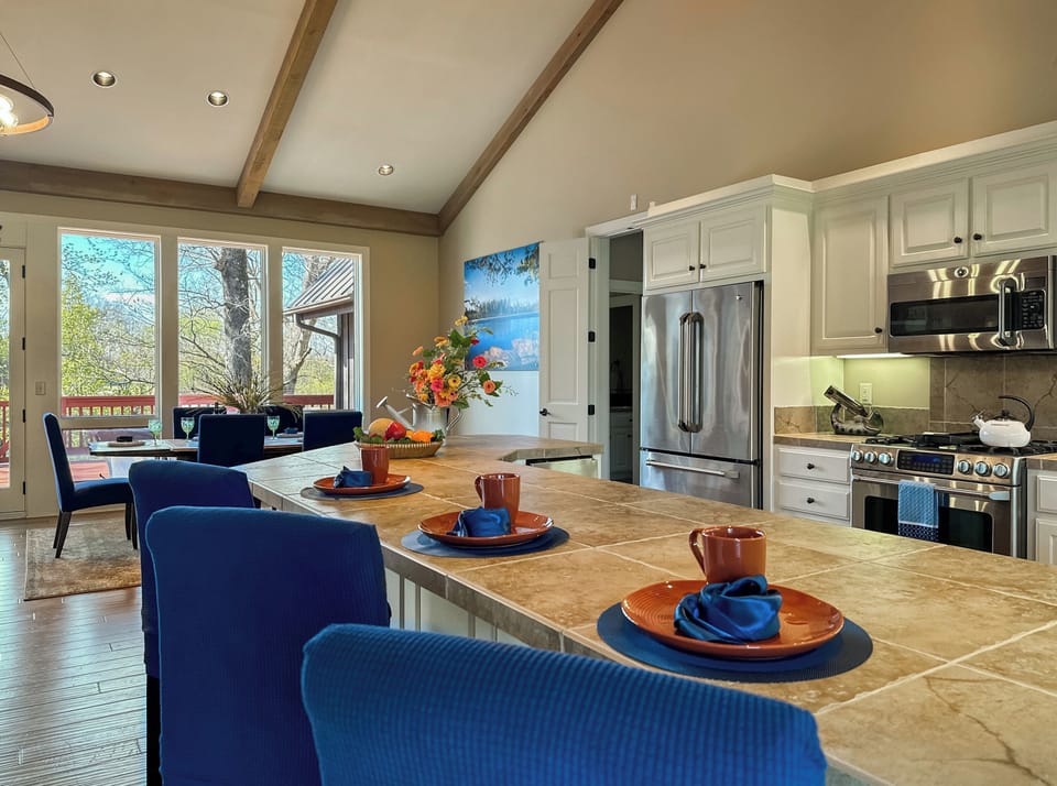 To the right there's a kitchen with island seating around it.