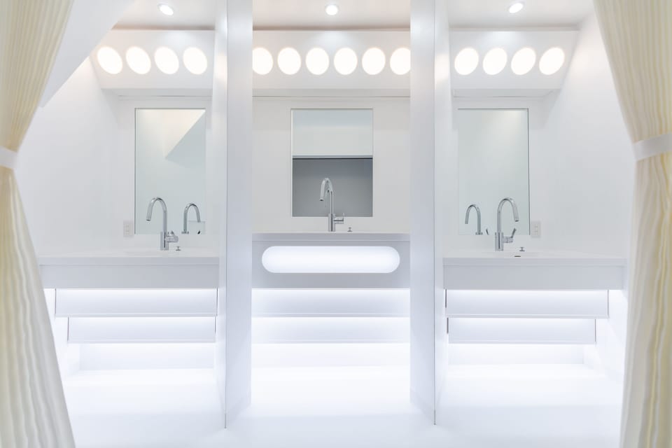 Designer toiletries, hair dryer, slippers, towels