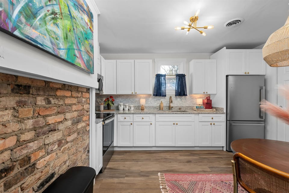 Kitchen with granite countertops and stainless-steel appliances 