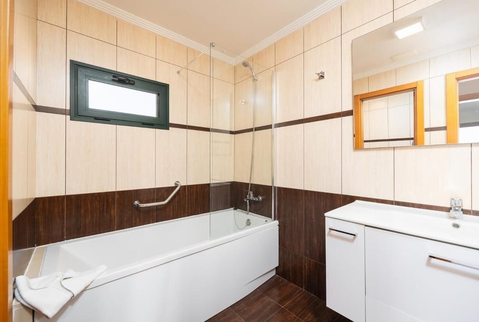 En suite bathroom with bath and shower