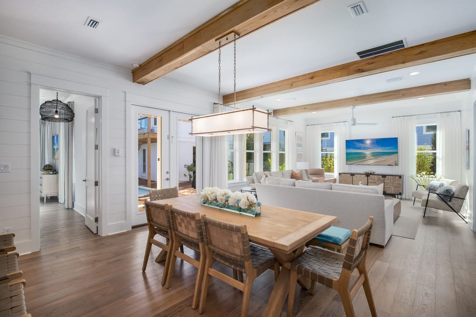Gather around this beautiful dining table while natural light streams through windows, creating the perfect space for memorable meals together.