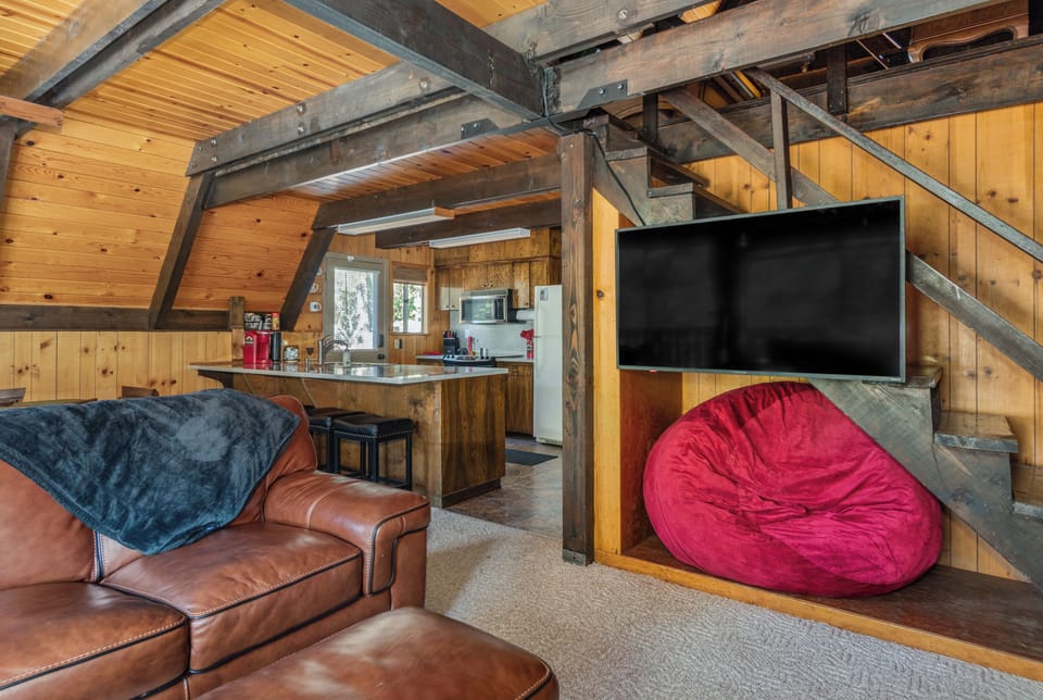 Enjoy relaxing on the couch or giant bean bag to enjoy entertainment on the TV.
