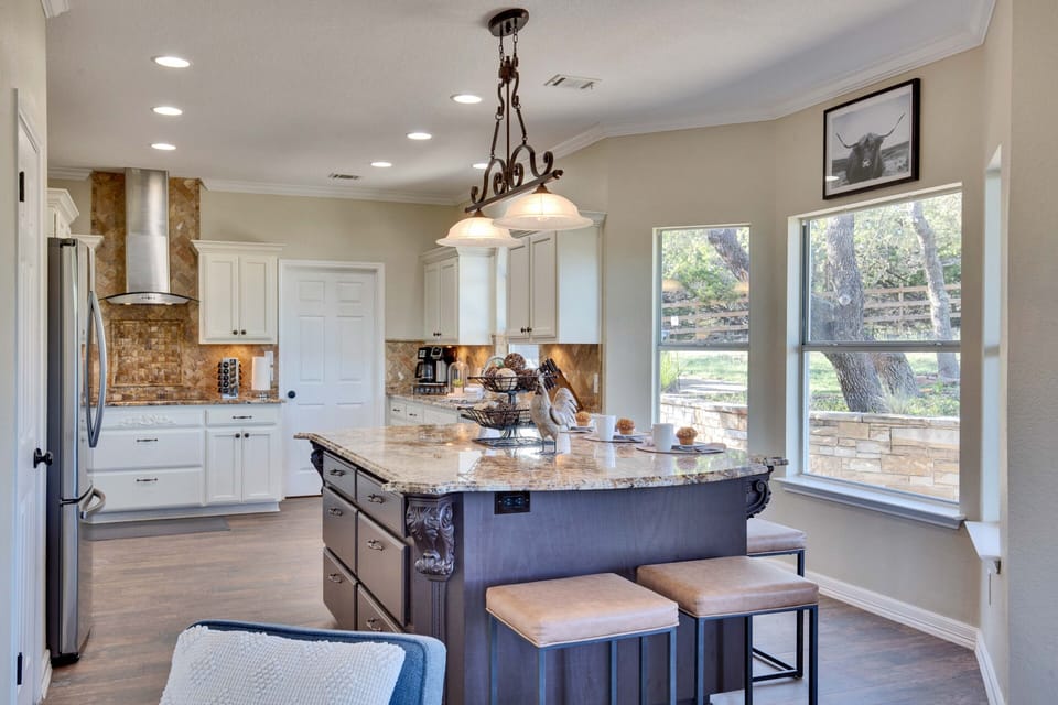 Island off the kitchen with seating for five.