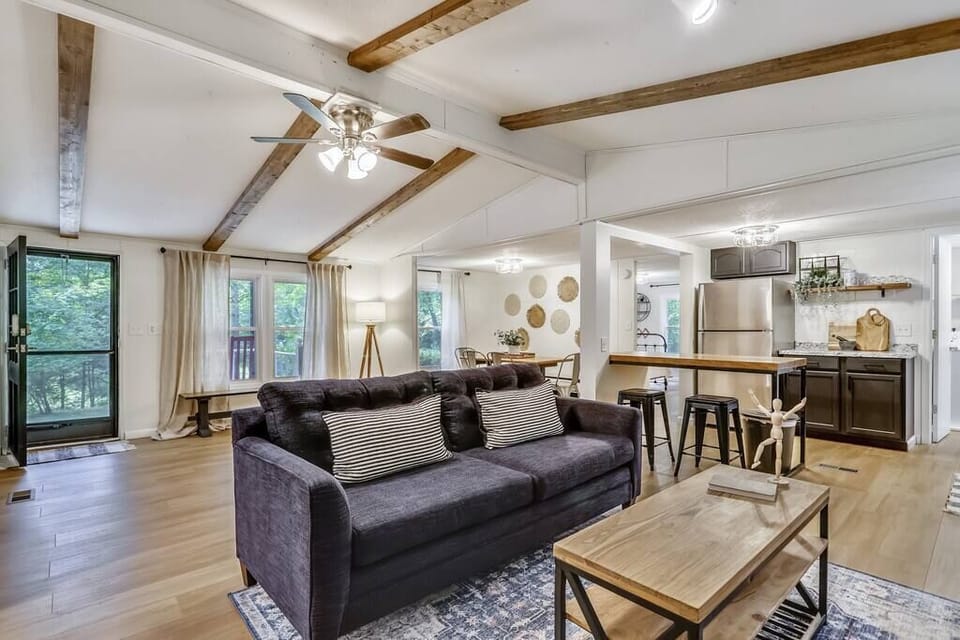 Living room, entry with desk, dining room, and kitchen