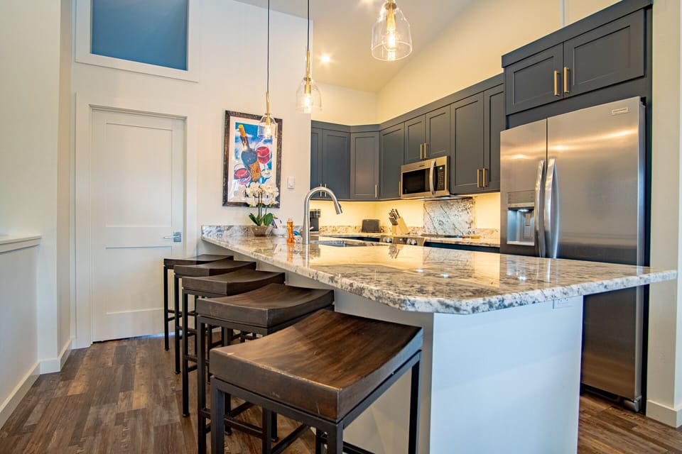 Newly-updated modern kitchen with bar stool seating