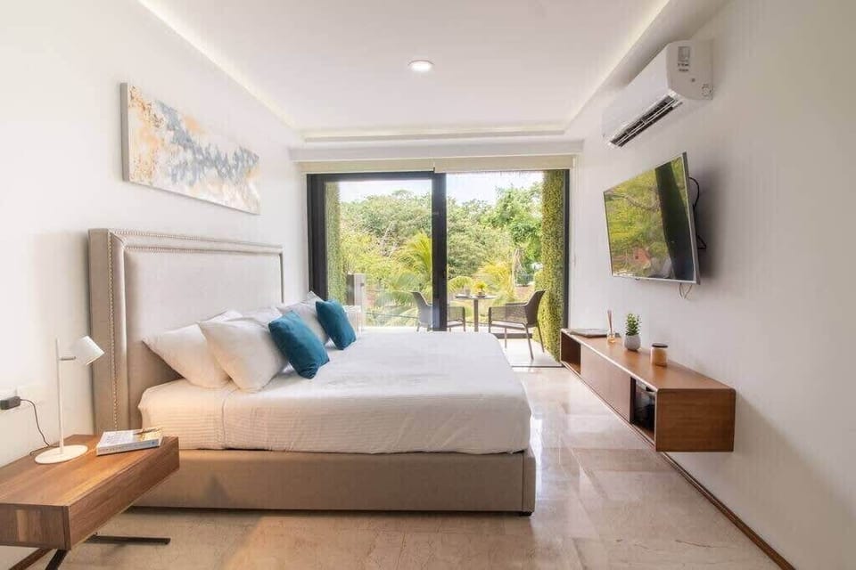 A plush king-size bed, natural light, and serene views for a restful stay.