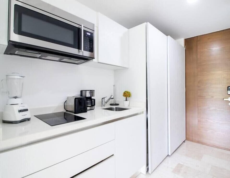 A sleek, modern kitchenette with all the essentials for a comfortable stay.