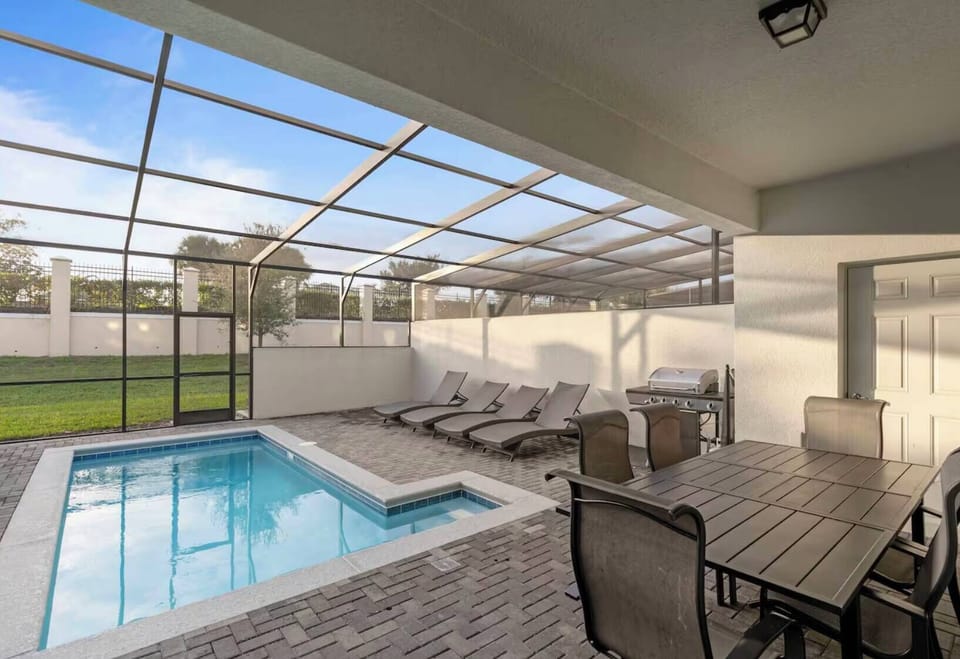 Step outside to your private oasis, where you can relax by the sparkling plunge pool on sleek lounge chairs. Enjoy meals in the spacious outdoor dining area, soaking up natural light beneath a protective screen enclosure.