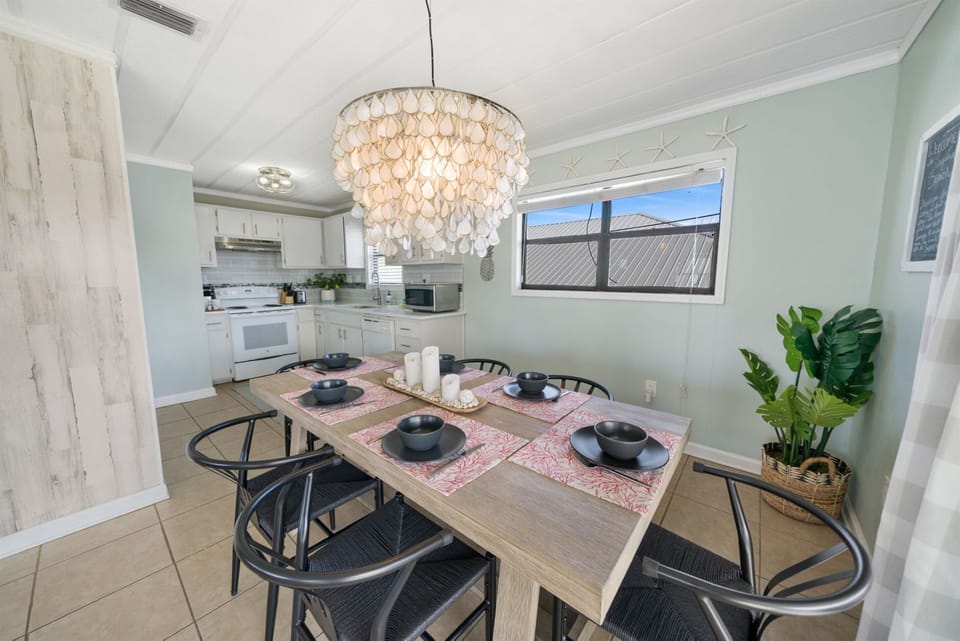 Comfortable chairs surround the table, inviting you to linger around the space, engaging in lively conversations. 