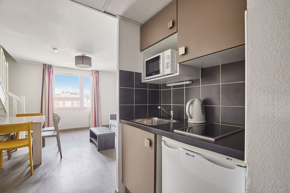Functional kitchenette with modern appliances and clean design ideal for easy in-room cooking.
