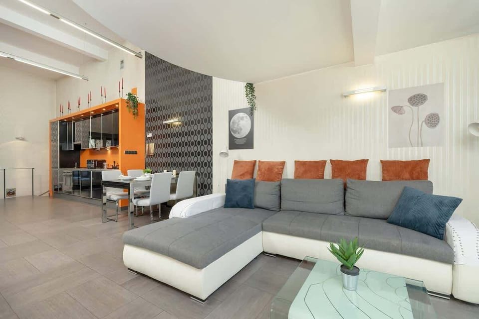 A comfortable seating area with plush grey armchairs, complementing the contemporary design of the space.
