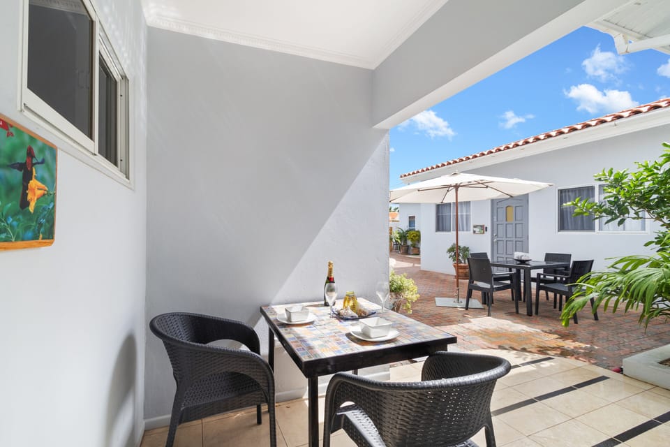 Refreshing Covered patio Area of the Apartment in Noord Aruba - 2 Persons Dining - Turn your meal into a brief getaway from indoor - Pleasant Atmosphere