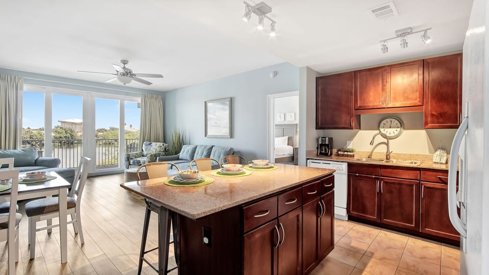 Open-concept kitchen and living area with natural light and balcony views