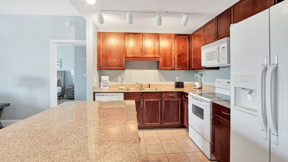 Modern kitchen with granite countertops and wooden cabinetry