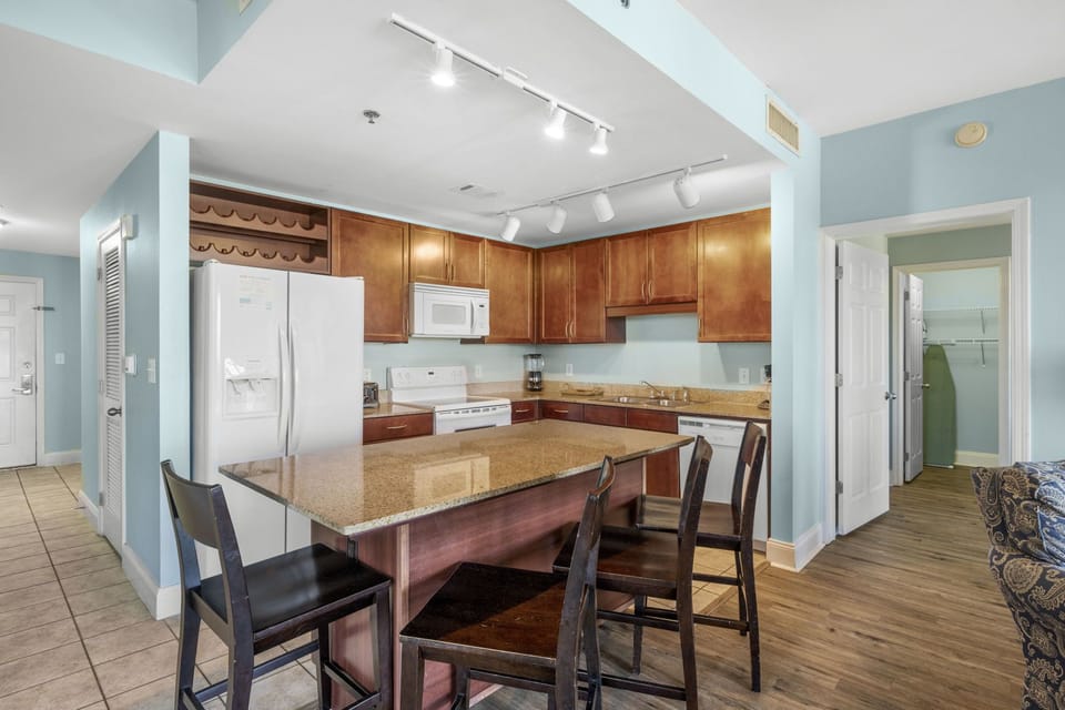 spacious kitchen with wooden cabinetry and a large island for dining