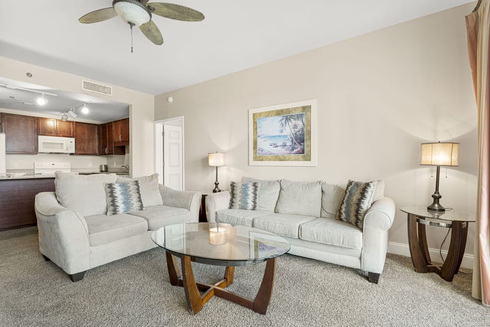 Relax in this modern living room with comfortable seating and a glass coffee table.