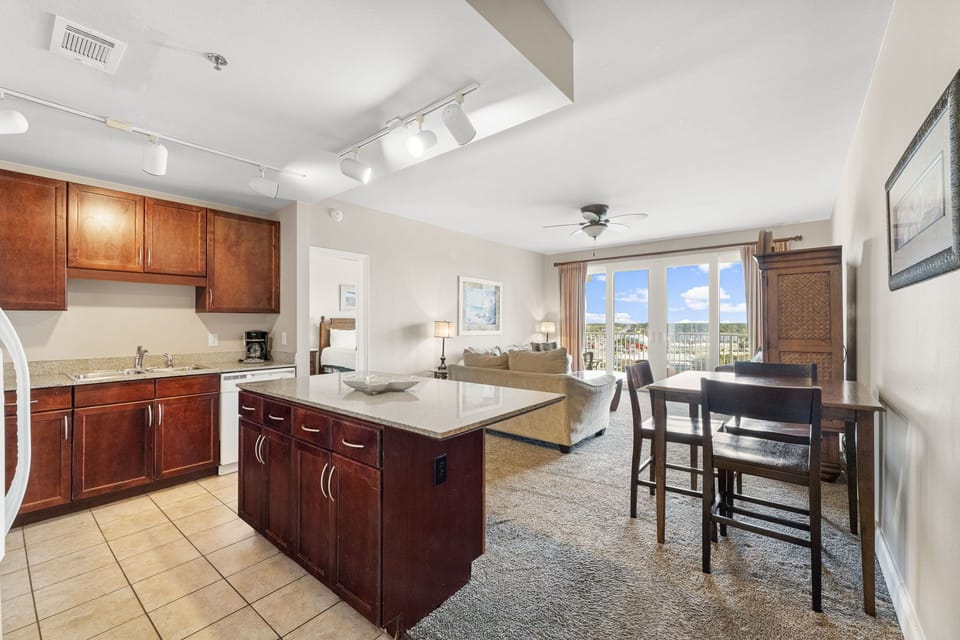 Open-concept kitchen and living area with natural light and city views