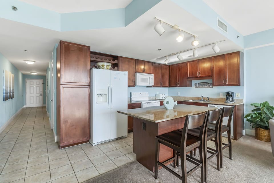 Modern kitchen with wooden cabinetry and a breakfast bar for casual dining