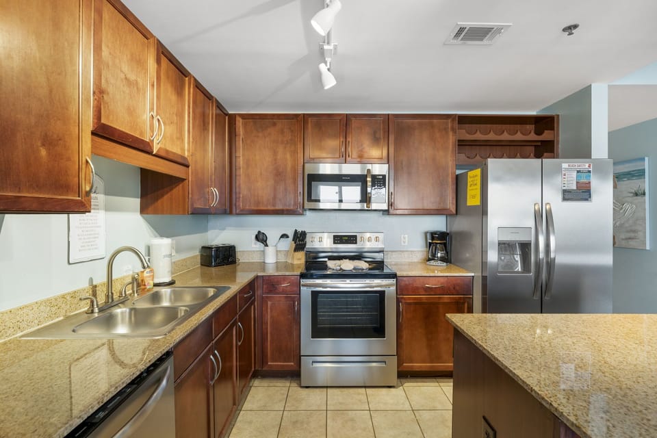 Modern kitchen with stainless steel appliances and granite countertops