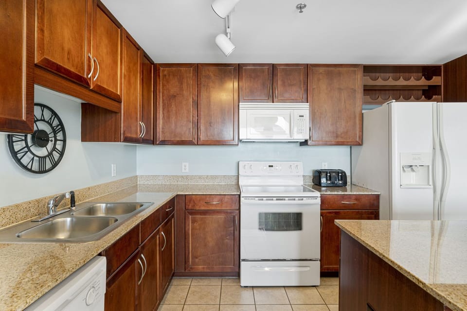 Kitchen with wooden cabinets and white appliances for a functional cooking space