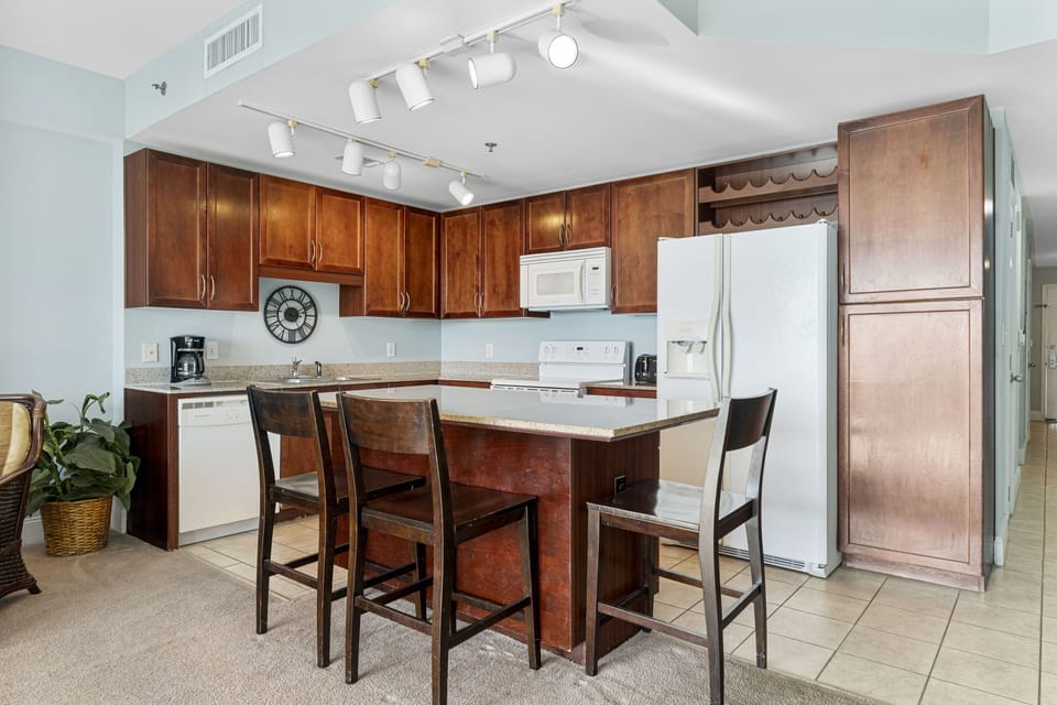 Modern kitchen with wooden cabinetry and a central island for casual dining.