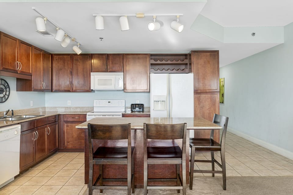 kitchen with dark wood cabinets and a breakfast bar with seating for three