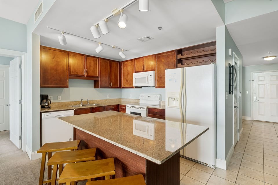 Modern kitchen with granite island and wooden cabinetry