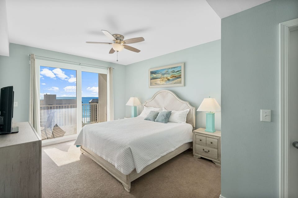 Relax in this coastal bedroom with ocean views and soft blue walls.