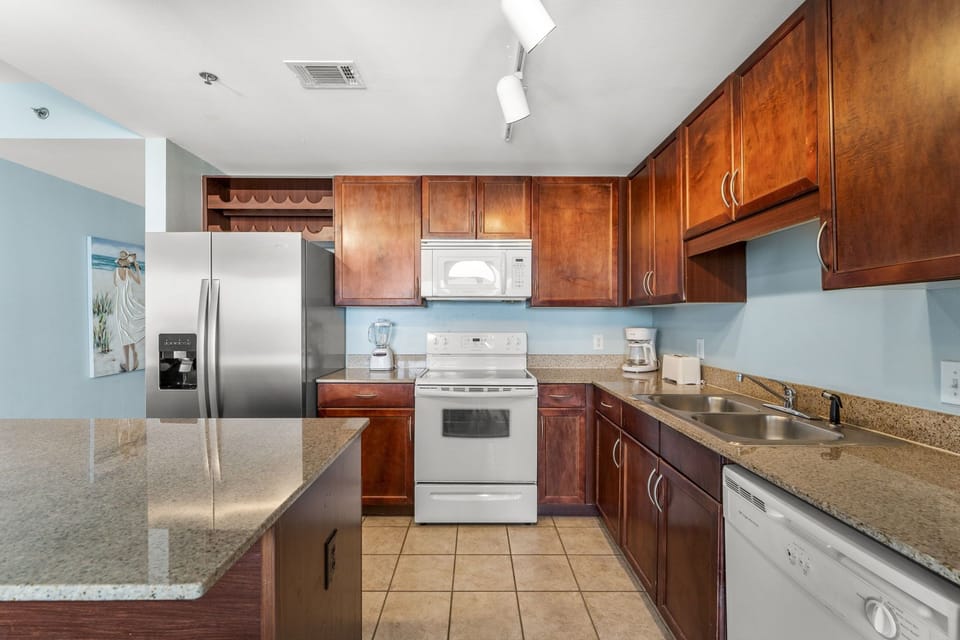 kitchen with stainless steel refrigerator and wooden cabinetry