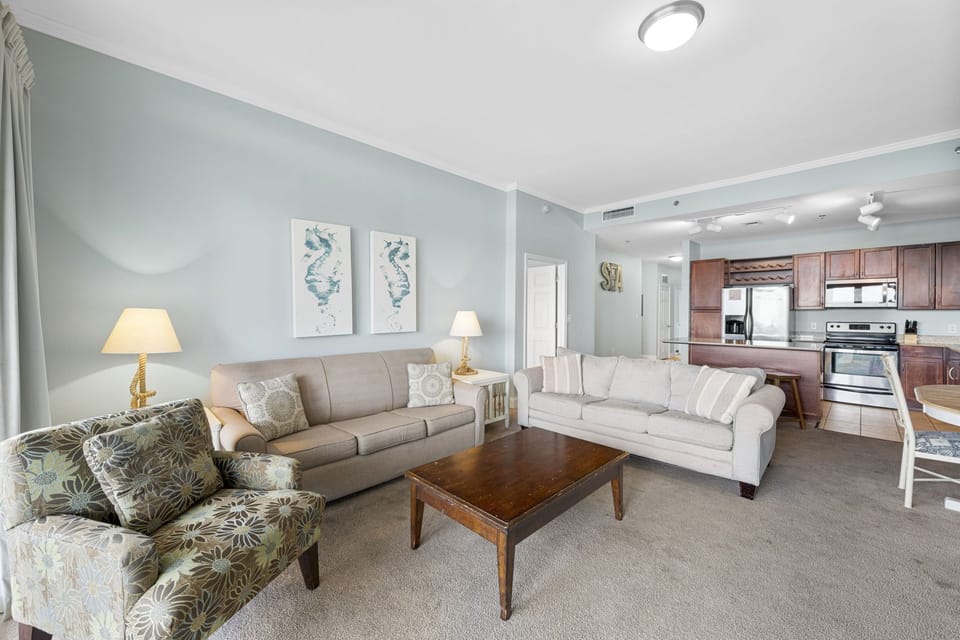 Spacious living room with comfortable seating and an open kitchen layout.