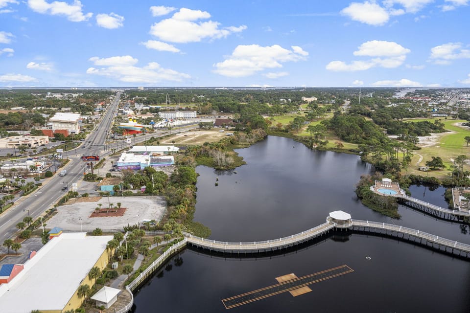 Scenic view of the lake and surrounding area with a curved boardwalk.