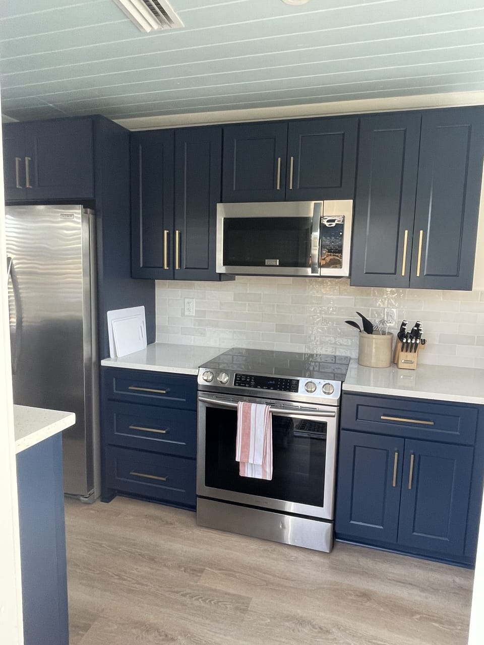 Brand new kitchen featuring new floors, subway tile, stainless appliances, 