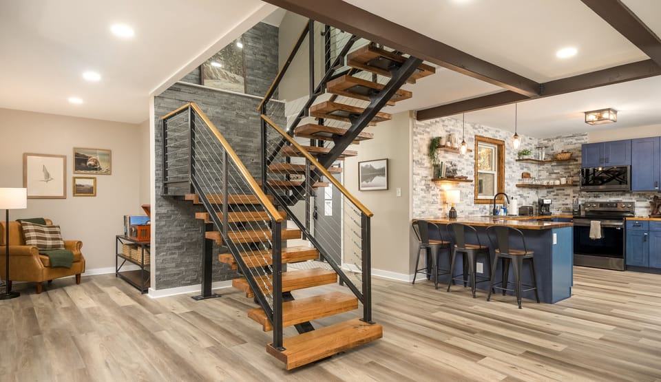 A modern staircase with rustic charm connects the home’s two levels, blending function with warm design details.