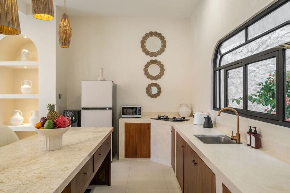 `Bright and airy kitchen space with modern amenities and rustic touches`