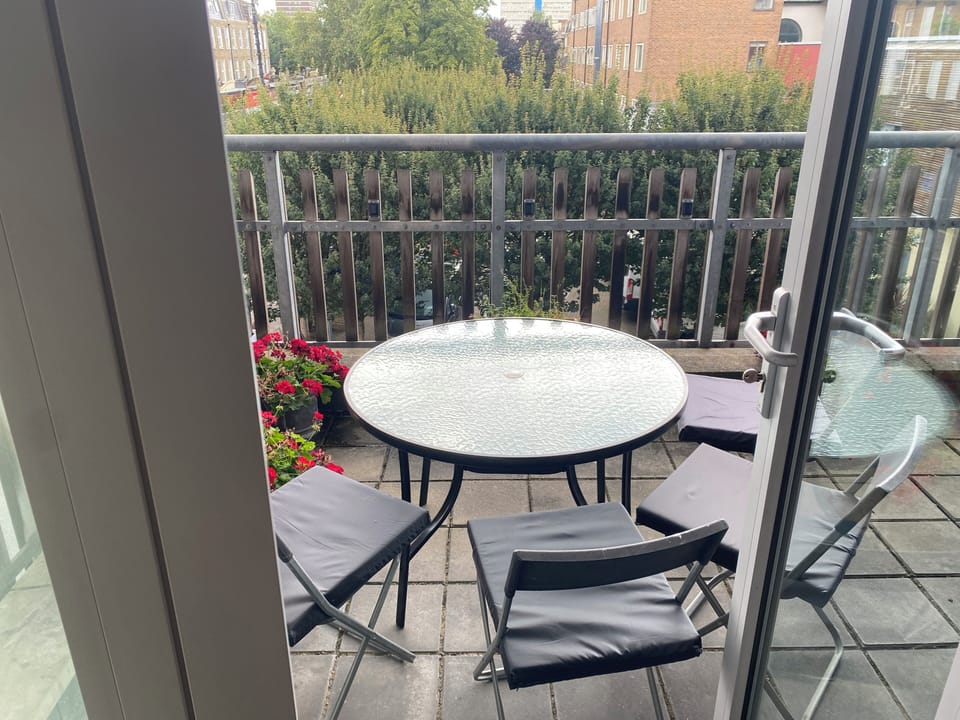 Dining table and 4 chairs on private terrace accessed from sitting room.