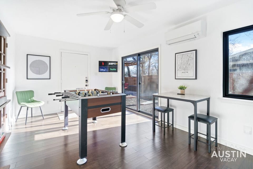 Awesome game room with foosball table, games, tv, bar table and, access to the patio