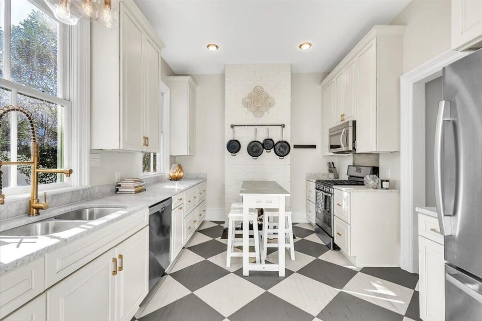 Kitchen with bar seating, dishwasher, gas burning stove, lots of cookware too!