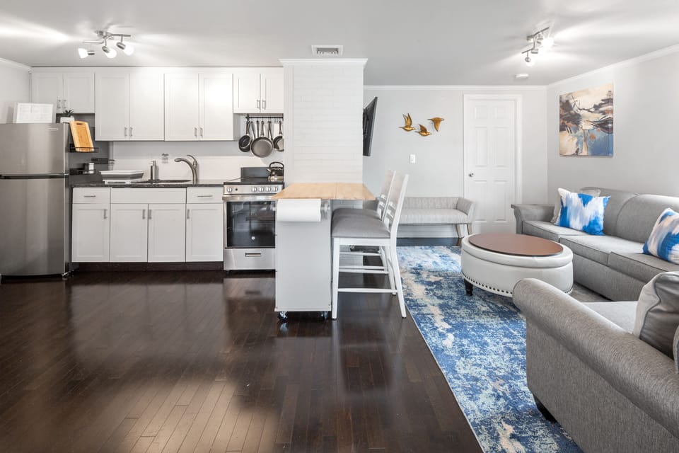 Cozy living room with a large tempur-pedic  pullout sofa, a love seat, cushioned bench, large HD flat screen smart tv with 180 degree mount and netflix included, also a large electric fireplace with great heating or the option to just have the visual, 