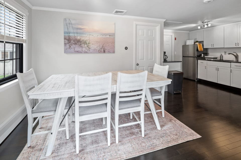 Large dining room table with a cushioned bench and 4 large chairs. Complete with a premium filtered water dispenser.