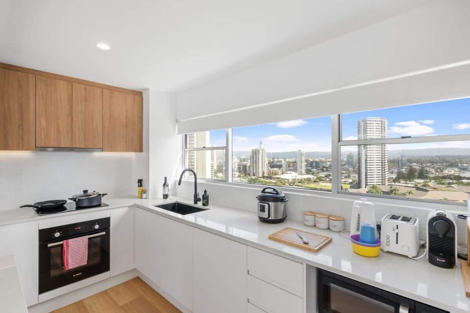 An impeccably appointed kitchen with modern appliances and sleek countertops, overlooking the breathtaking Western vistas of the Gold Coast.
