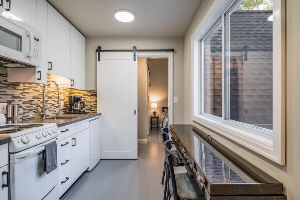 The well stocked kitchen is common space shared between you and your guests with a beautiful handmade table that can seat 2 or open up to comfortably seat 4.