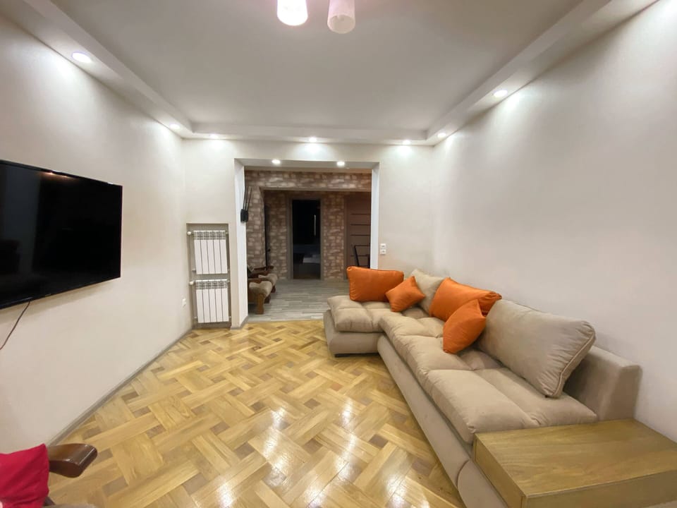 Deluxe Apartment, 4 Bedrooms | Living area | Flat-screen TV