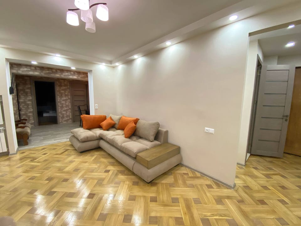Deluxe Apartment, 4 Bedrooms | Living area | Flat-screen TV
