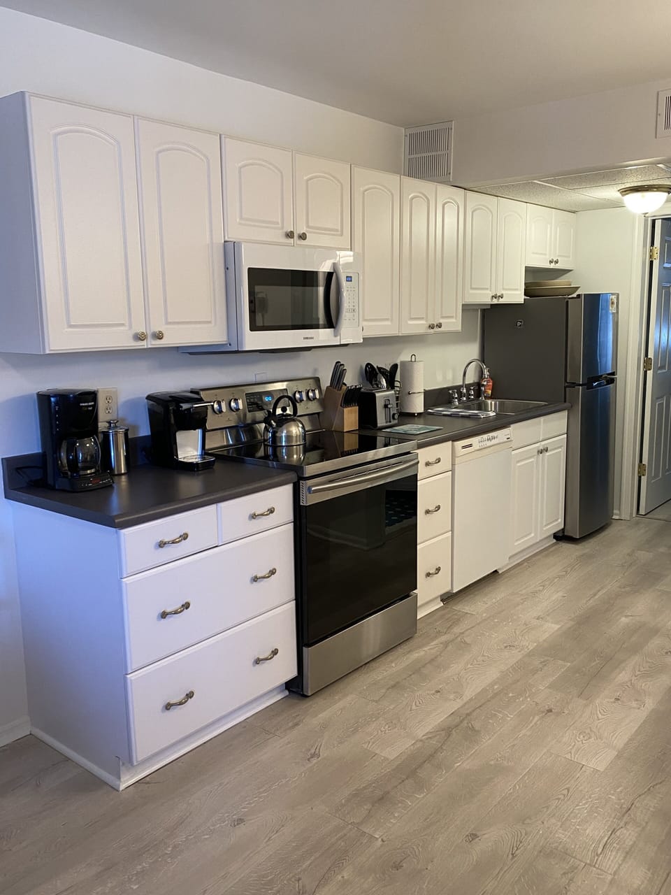 Galley Kitchen with Stainless Steel Appliances and Full Size Dish Washer