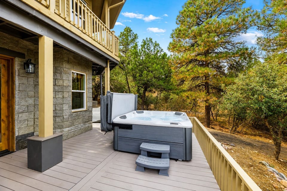Private hot tub beneath the pines with open-sky evening views