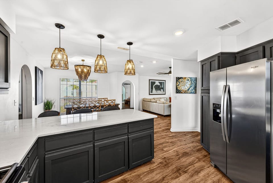 Gather around the spacious kitchen island with elegant pendant lighting, gleaming countertops, and stainless steel appliances—where every meal feels like a celebration.