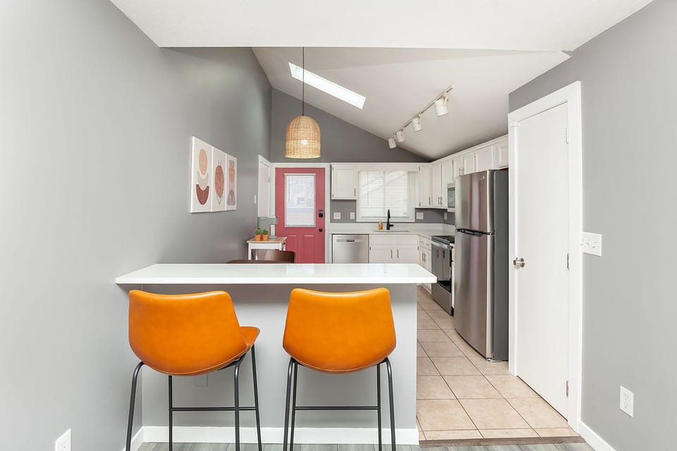 Bar top with two comfortable barstools for additional dining seats overlooking.